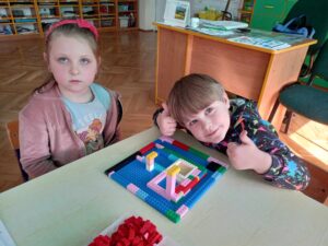 Dzieci prezentujące swoje konstrukcje z klocków.